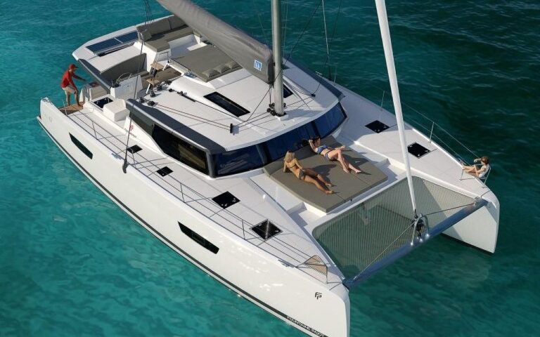 sunbathing on a Fountaine 47 boat. Boats in Paros. Charter a Boat.